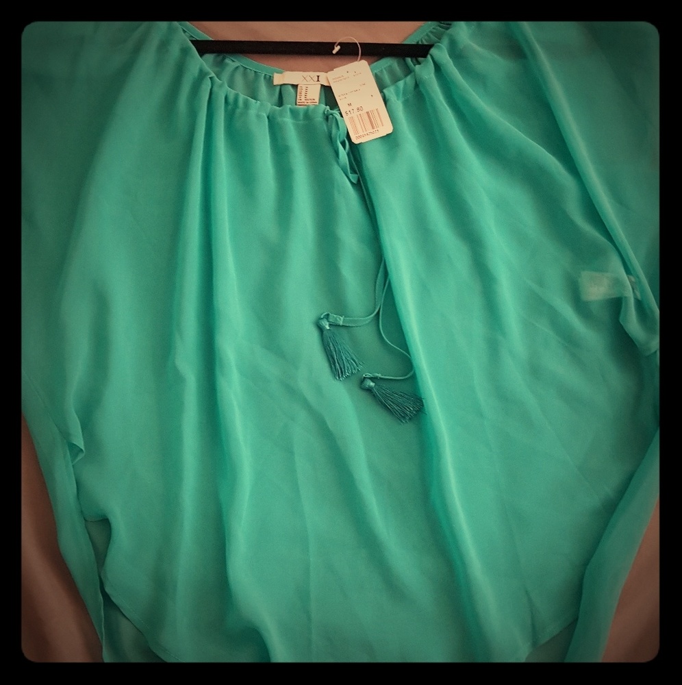 A teal sheer top